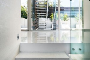 Schodiště poskytují působivé průhledy do exteriéru a zejména do okolní zeleně. Okna díky tomu vlastně nahrazují dekorace v maximálně minimalisticky pojatém prostoru. FOTO DMAX