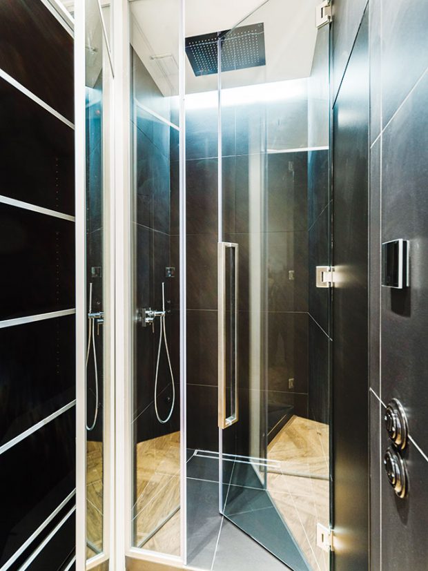 Sprchový kout se nachází vně zasklené kostky, v níž je umístěna vana a samostatně stojící umyvadlo. FOTO TOMÁŠ MALÝ
