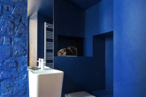 Indigo modrá toaleta s bílou sanitou