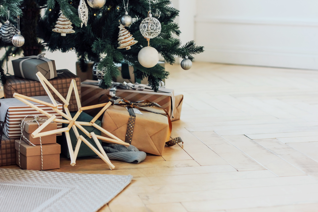 Gifts under decorated Christmas tree, minimalistic Scandinavian