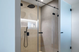Bílá moderní koupelna s velkým sprchovým koutem