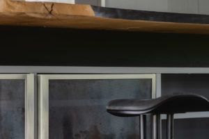 Kuchyň v šedé a černé v moderním stylu s barovými židlemi detail