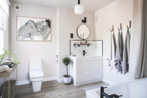 Bílá koupelna s dřevěnou podlahou