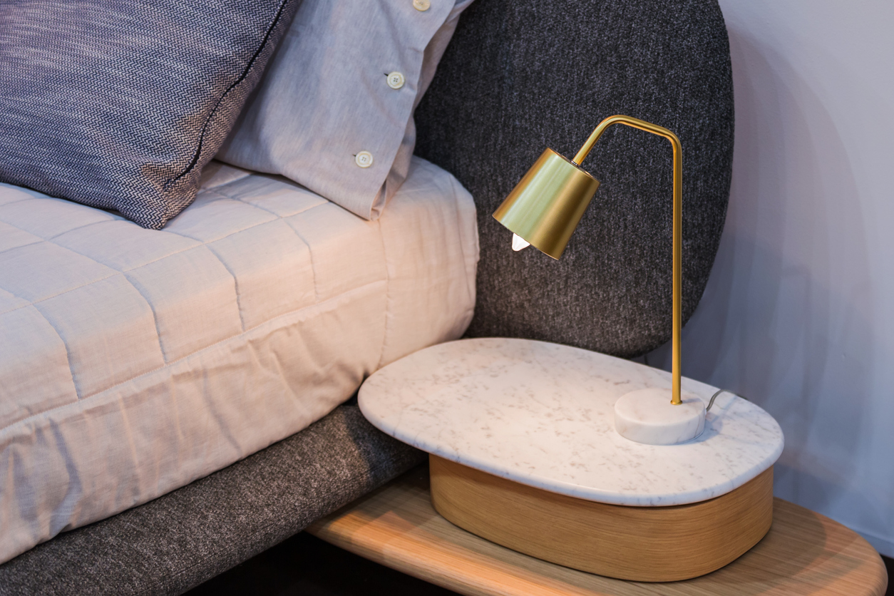 Gold brass lamp on bedside table decor in the interior