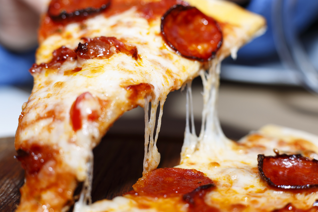 Closeup of a piece of pepperoni pizza. Italian pizza.