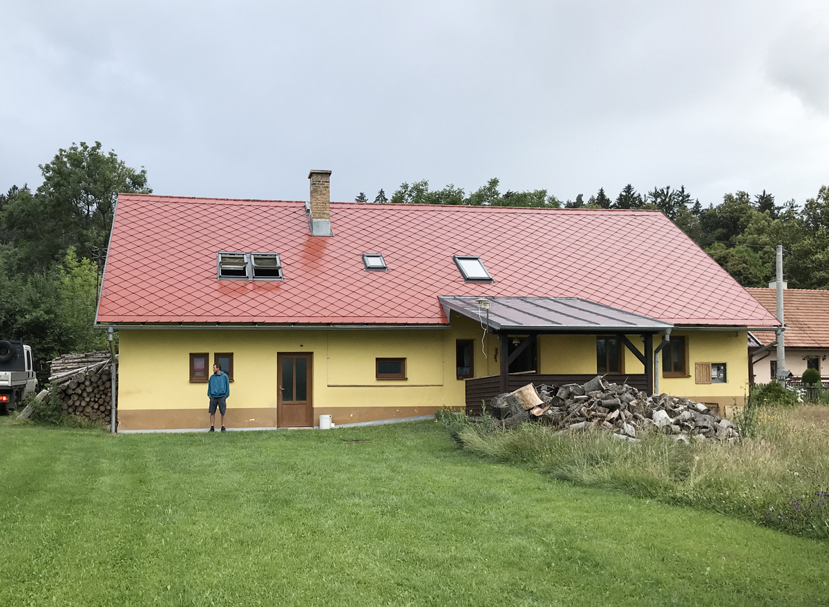 Chalupa se žlutou fasádou a červenou střechou