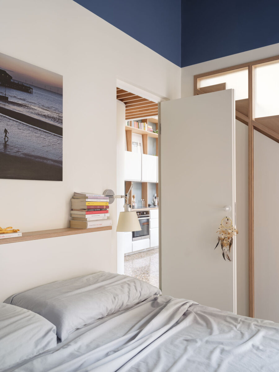 Světlá moderní ložnice laděná do modra s přírodními dřevěnými prvky