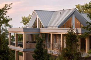 Pohled na horní podlaží domu ukazuje, jak se geometrie trojúhelníků a písmena A opakuje na fasádě a zachytává světlo