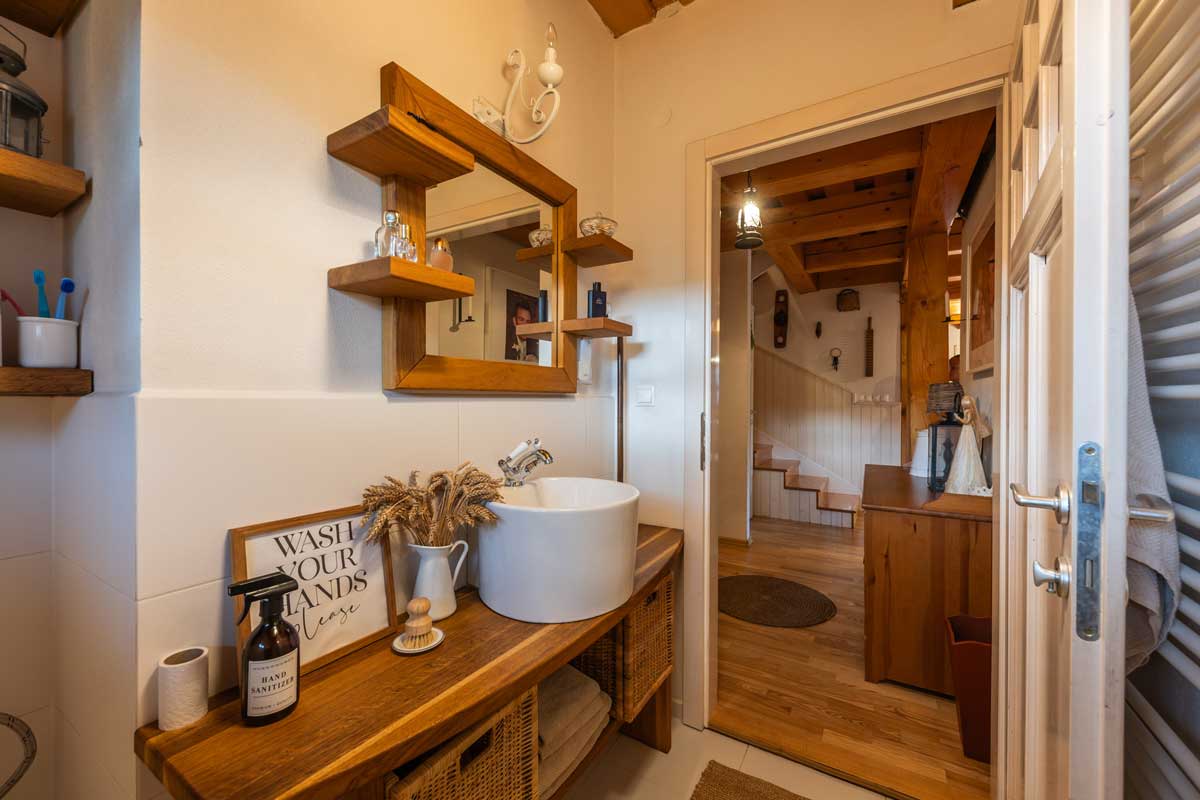 Koupelna s dřevěnou deskou a přírodními dekoracemi.