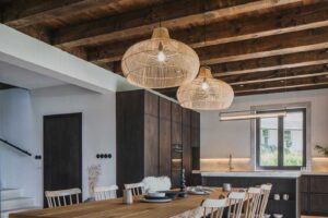 Jídelna s masivním stolem, dřevěnými židlemi a přírodním světlem v chalupě