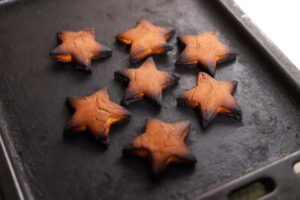 Plech se zcela připáleným vánočním cukrovím ve tvaru hvězdiček.