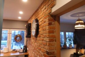 Přiznaná cihlová zeď v interiéru panelákového bytu