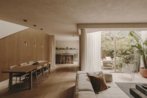 Obývací a jídelní prostor s velkými prosklenými plochami orientovanými do soukromého dvora