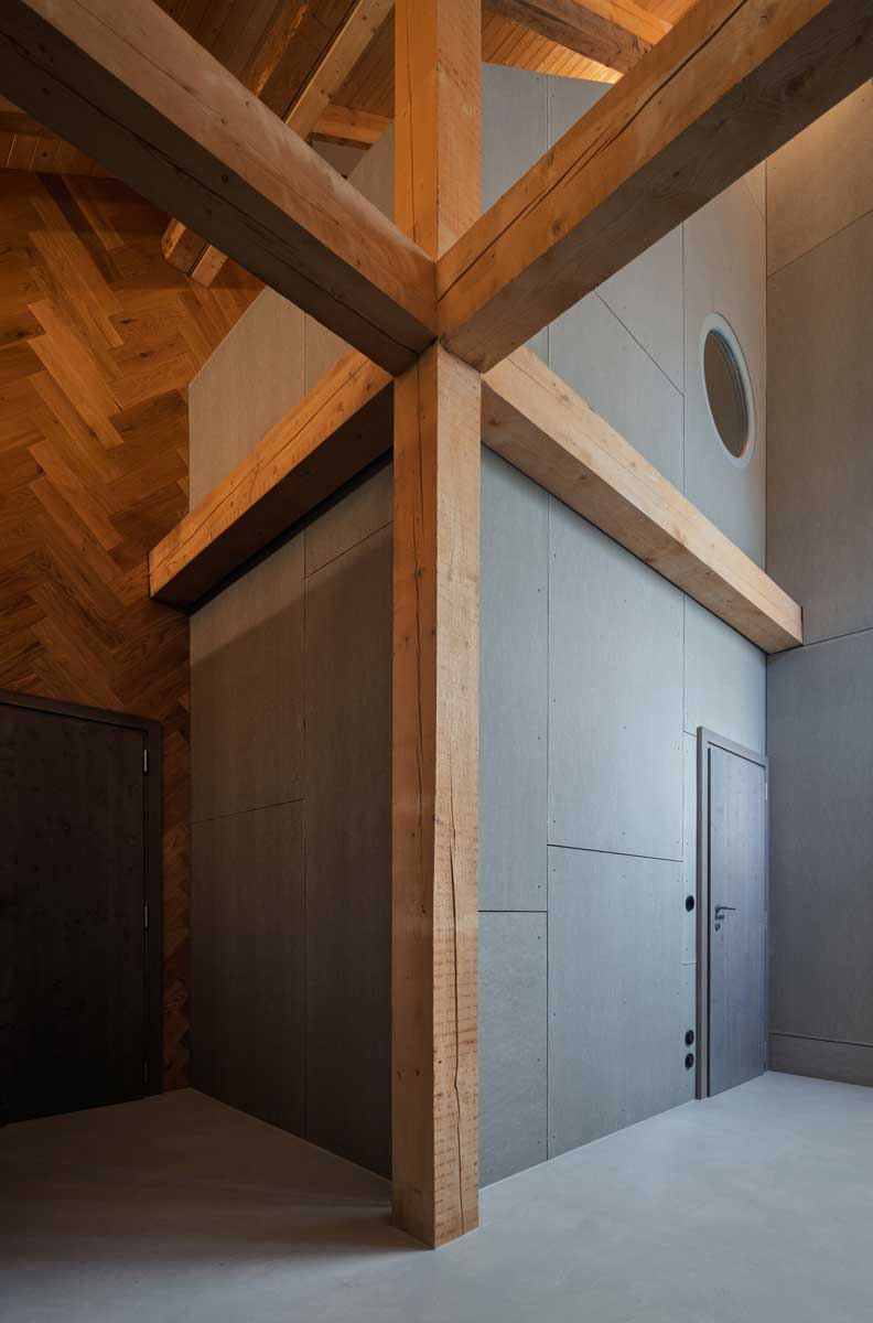 Detail křížení dřevěných trámů v interiéru stodoly se současnou vestavbou