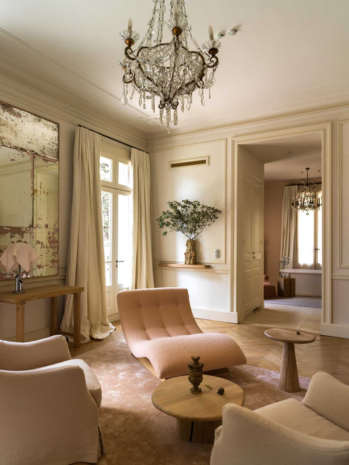 Společenská zóna se světlou sedačkou, historickými prvky a výhledem do parku