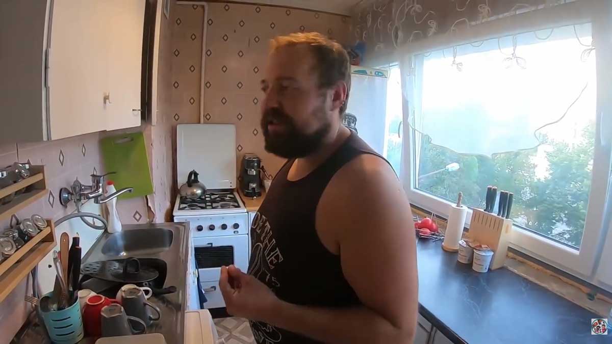 Původní kuchyňská linka v panelákovém bytě před rekonstrukcí, úzký pracovní prostor a zastaralé spotřebiče