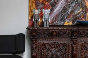 Vyřezávaná historická skříň s moderními dekoracemi a uměleckým obrazem