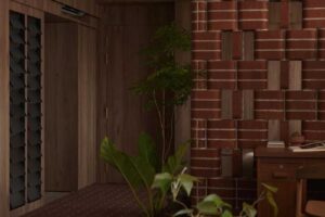 Zakřivená cihlová stěna jemně odděluje pracovní kout od vstupní části bytu a vytváří pocit malého parku uvnitř interiéru.