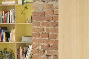 Detail přiznané cihlové stěny a betonových konstrukcí v interiéru bytu po rekonstrukci