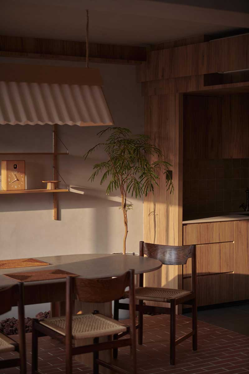 Detail jídelního koutu ukazuje hru přirozeného světla, dřeva a pokojových rostlin, které vytvářejí klidnou atmosféru.
