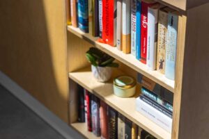 Vestavná knihovna v kuchyňském ostrůvku nízkoenergetické dřevostavby ze světlé překližky