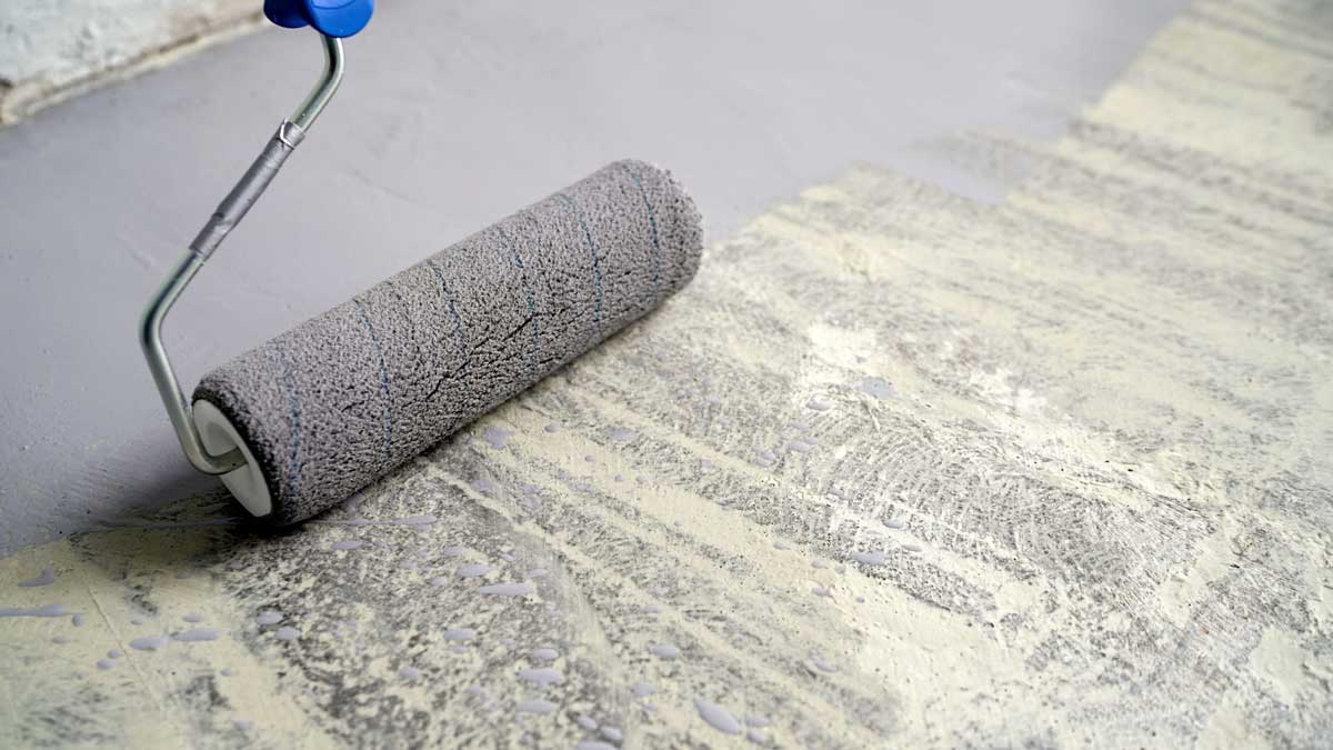 Penetrační nátěr nanášený válečkem na betonový podklad před nivelací nebo lepením podlahy