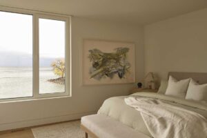 Ložnice s velkým oknem nabízí nerušený výhled na klidnou hladinu jezera