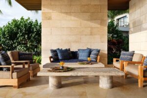 Venkovní posezení s dřevěným nábytkem a textiliemi v neutrálních tónech