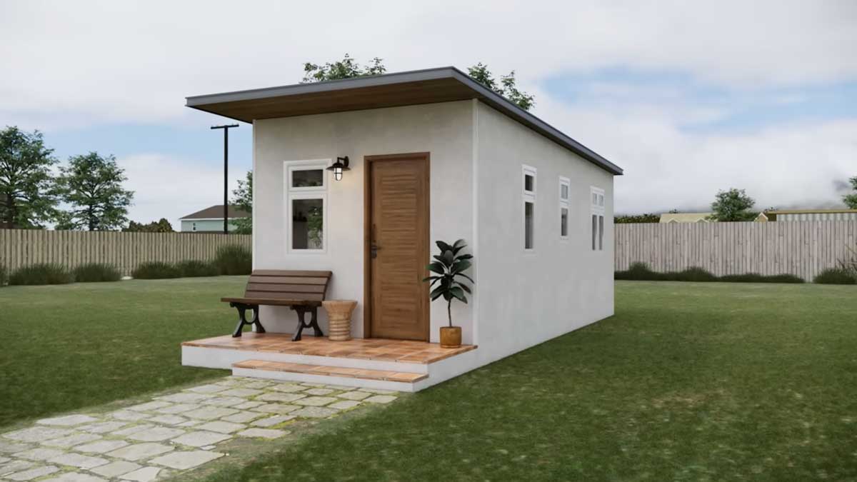 Moderní tiny house s minimalistickou fasádou a malou terasou před vstupem.