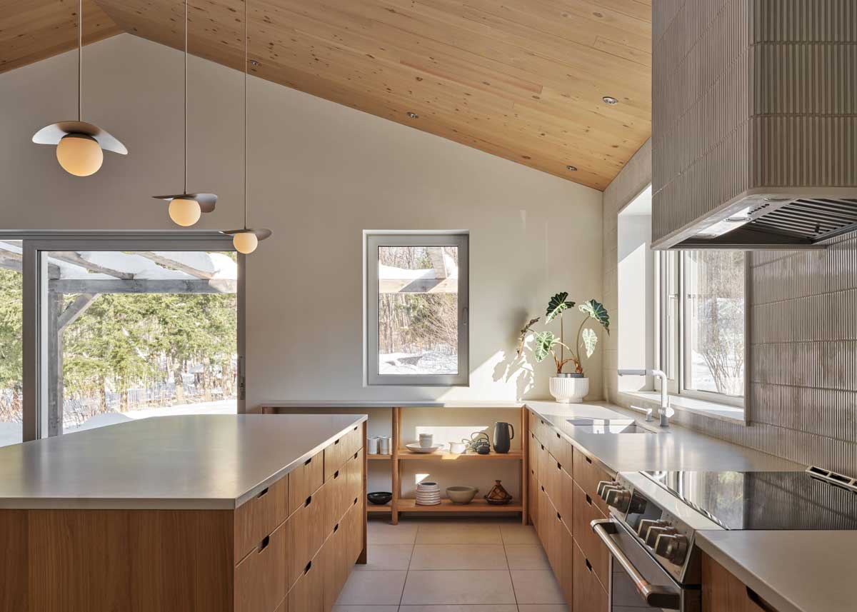 Prostorná kuchyň s masivním ostrůvkem, dřevem a světlými materiály vytváří funkční a klidné zázemí