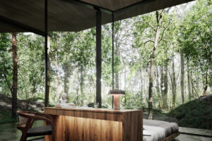 Ložnice s celoprosklenými stěnami otevírá interiér do korun stromů a nechává přírodu vstoupit dovnitř.