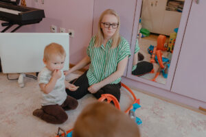 Zrcadlová skříň v dětském pokoji odráží hračky, nábytek a běžný každodenní ruch domácnosti.