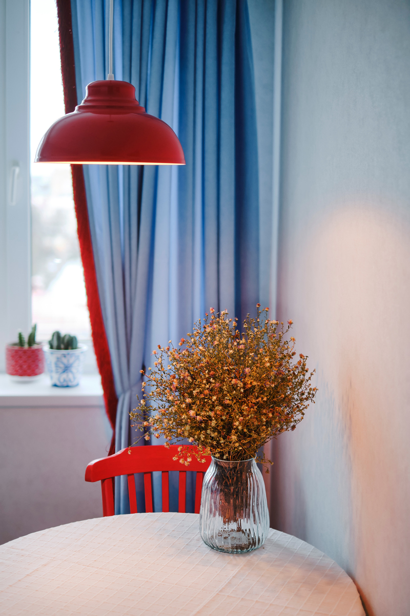 Červená lampa a židle oživují jinak jemně laděný interiér a ukazují princip takzvané unexpected red theory.